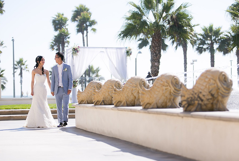 Couple taking photo at the Hyatt Huntington Beach after their first look as a great wedding ceremony ideas http://RoyceWeddings.com Call: 626-560-2537