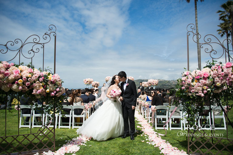 Picture perfect wedding ceremony with beautiful wedding flower arrangements at a hotel wedding venue in Orange County http://RoyceWeddings.com Call: 626-560-2537