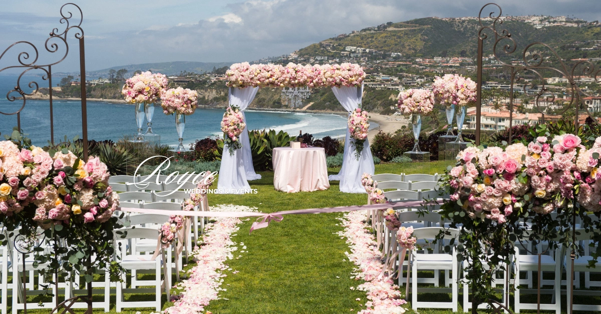 Luxury coastal wedding ceremony overlooking the ocean with elegant floral design