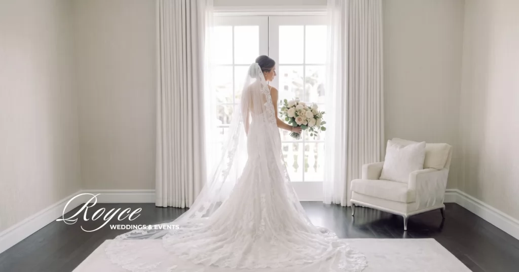 Elegant Santa Barbara bride in wedding gown holding bouquet during bridal preparation
