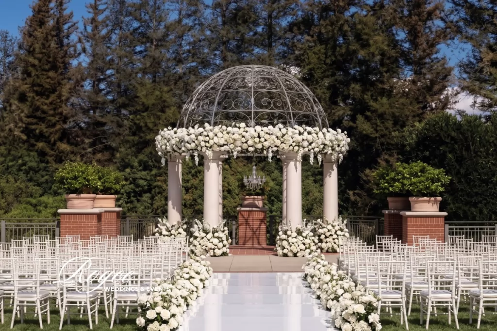 Four Seasons Westlake Wedding outdoor ceremony at Garden Lawn with elegant floral decor