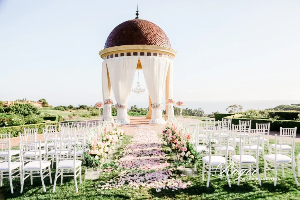 Blush and pastel-themed wedding ceremony at Pelican Hill, designed by Los Angeles wedding planners.