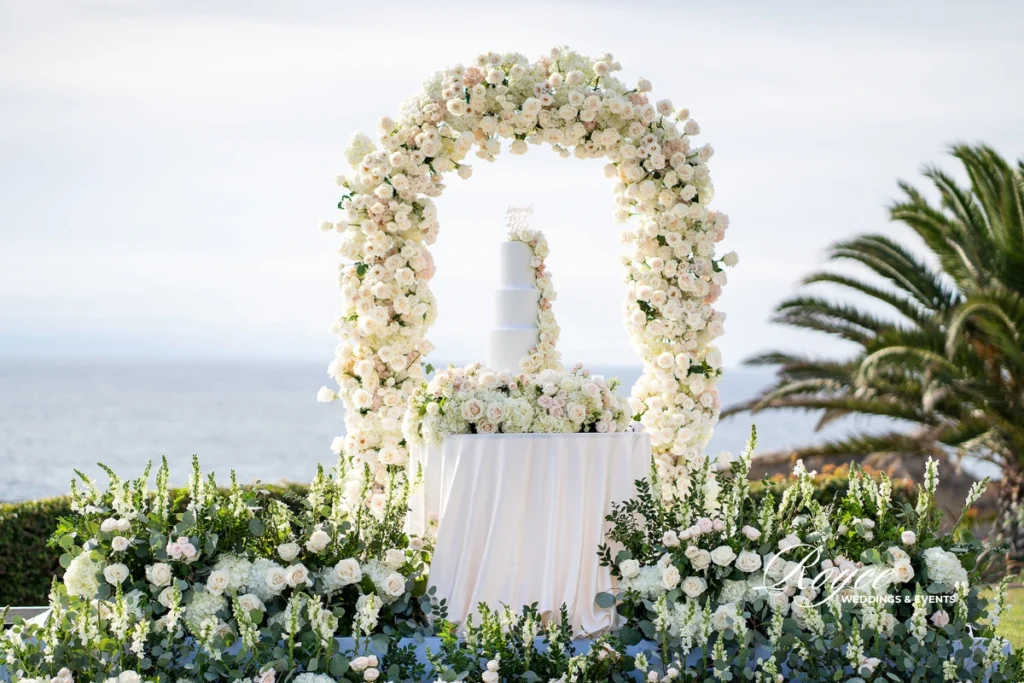 Elegant oceanfront wedding cake display at Montage Laguna Beach, styled by Royce Weddings & Events.