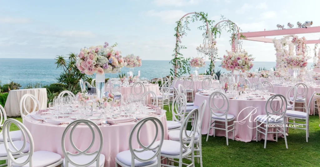 Oceanfront reception at Montage Laguna Beach with chandeliers and pastel tablescape